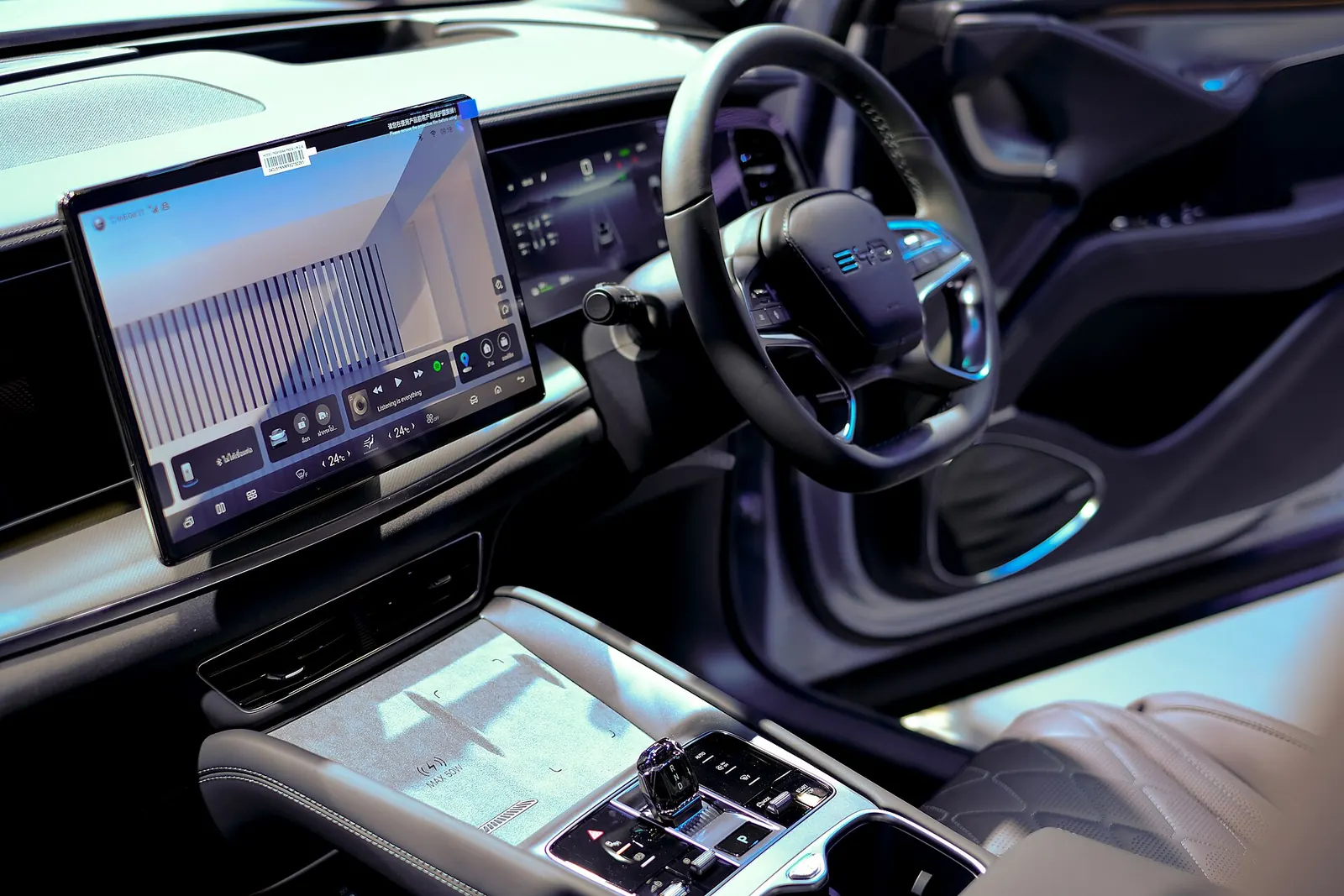 Right-hand-drive cockpit of the Sealion 7: rotating touchscreen, digital driver display, steering wheel and centre console