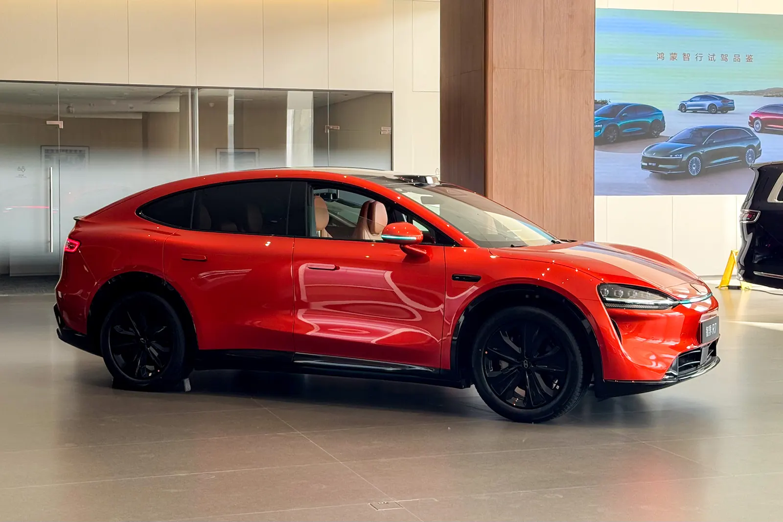 Side view of a red Luxeed R7 in a showroom