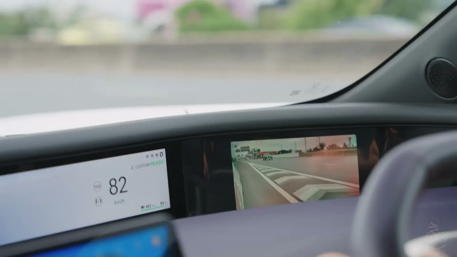 The Avatr 07's wide instrument display showing speed and a camera view while driving