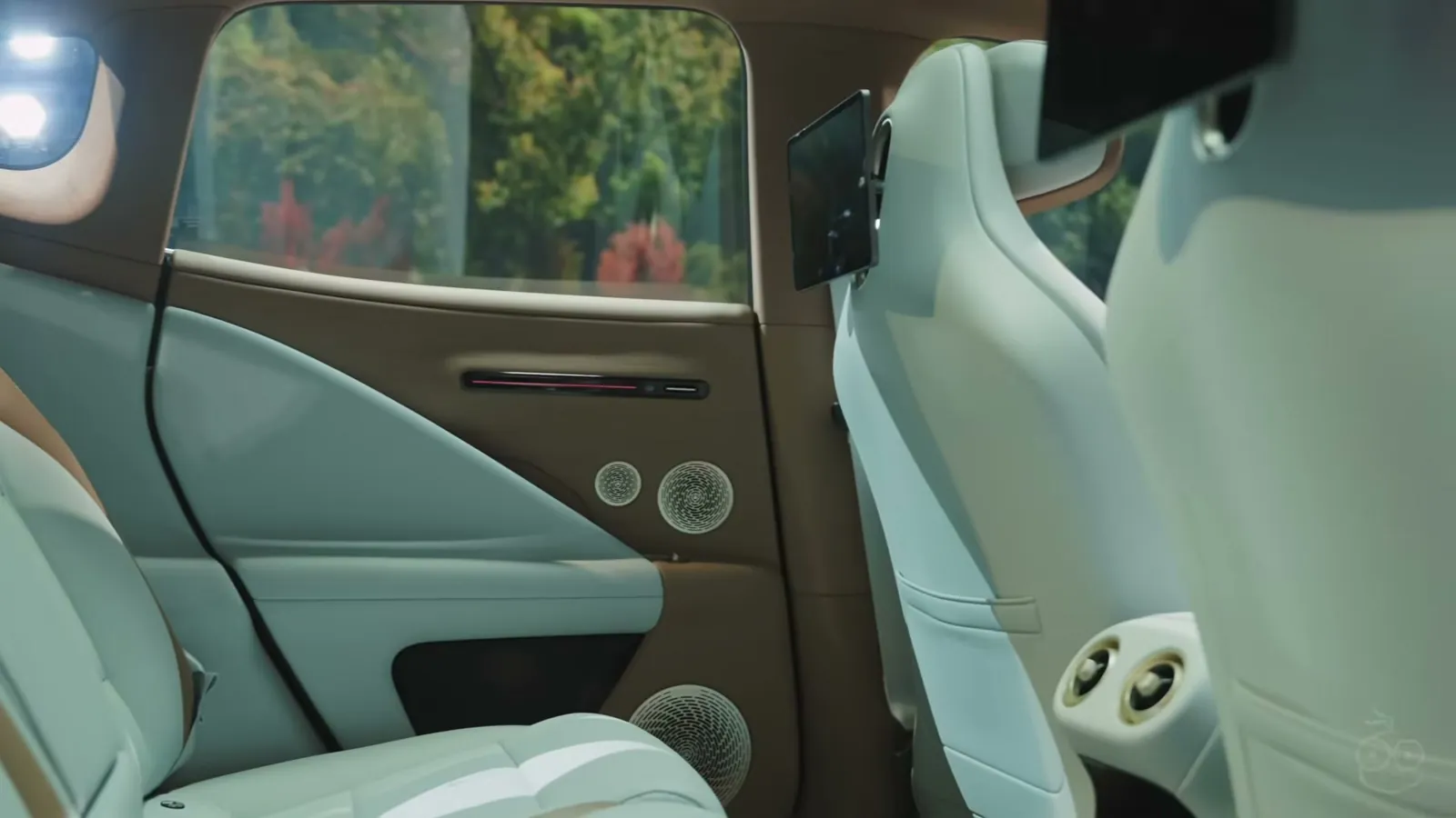 Rear door and seats of the Avatr 07 with door speakers, a seat-back tablet and rear air vents