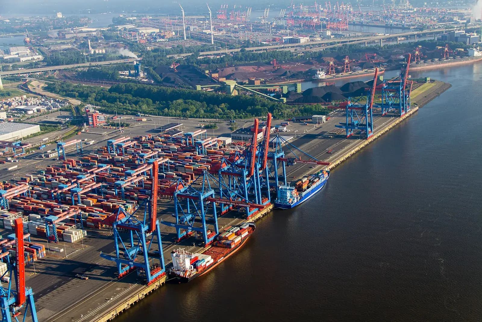 Aerial view of a container terminal with gantry cranes and ships