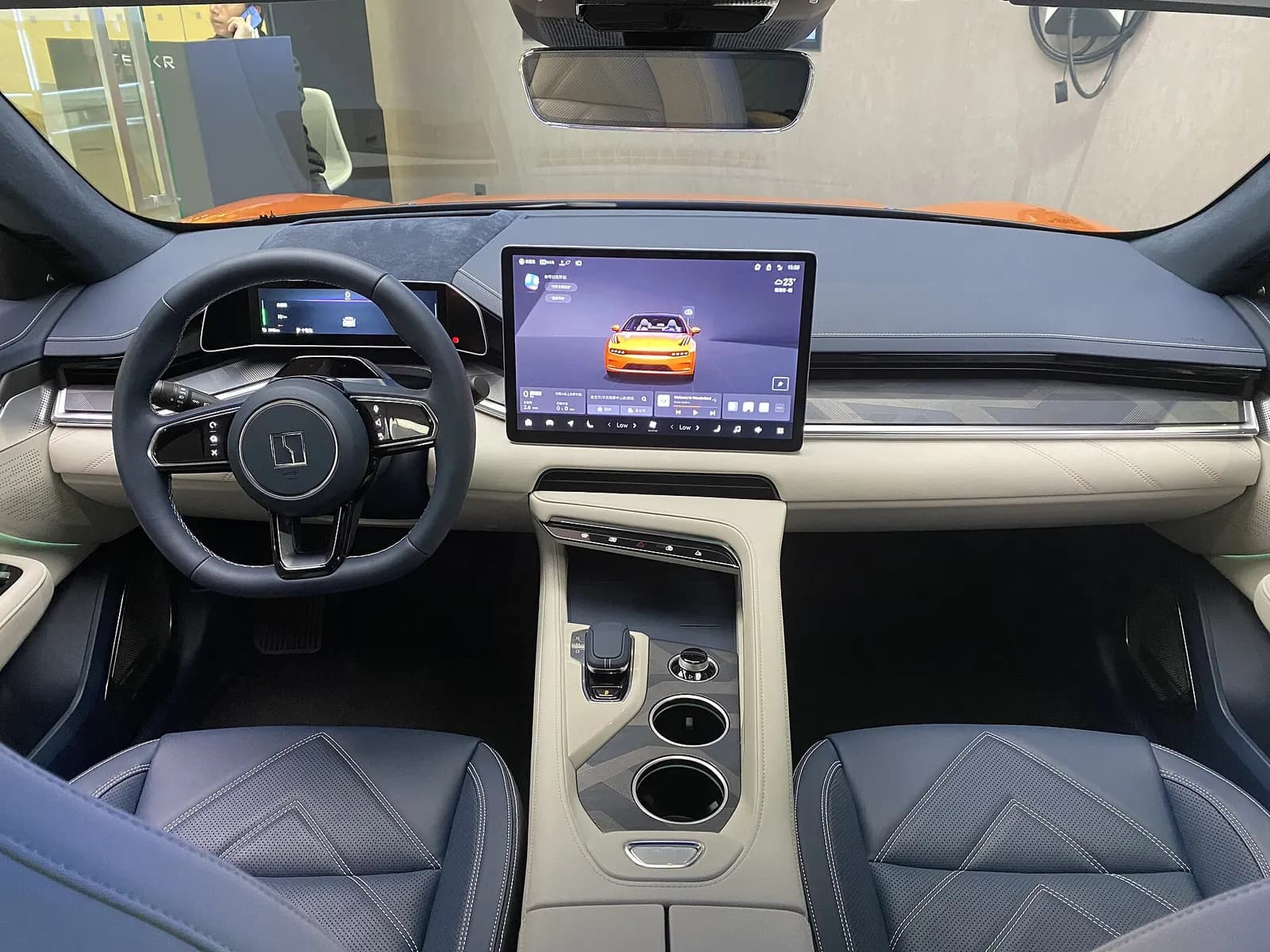 Cockpit of the Zeekr 001: steering wheel, digital cluster, large central touchscreen and two-tone leather seats