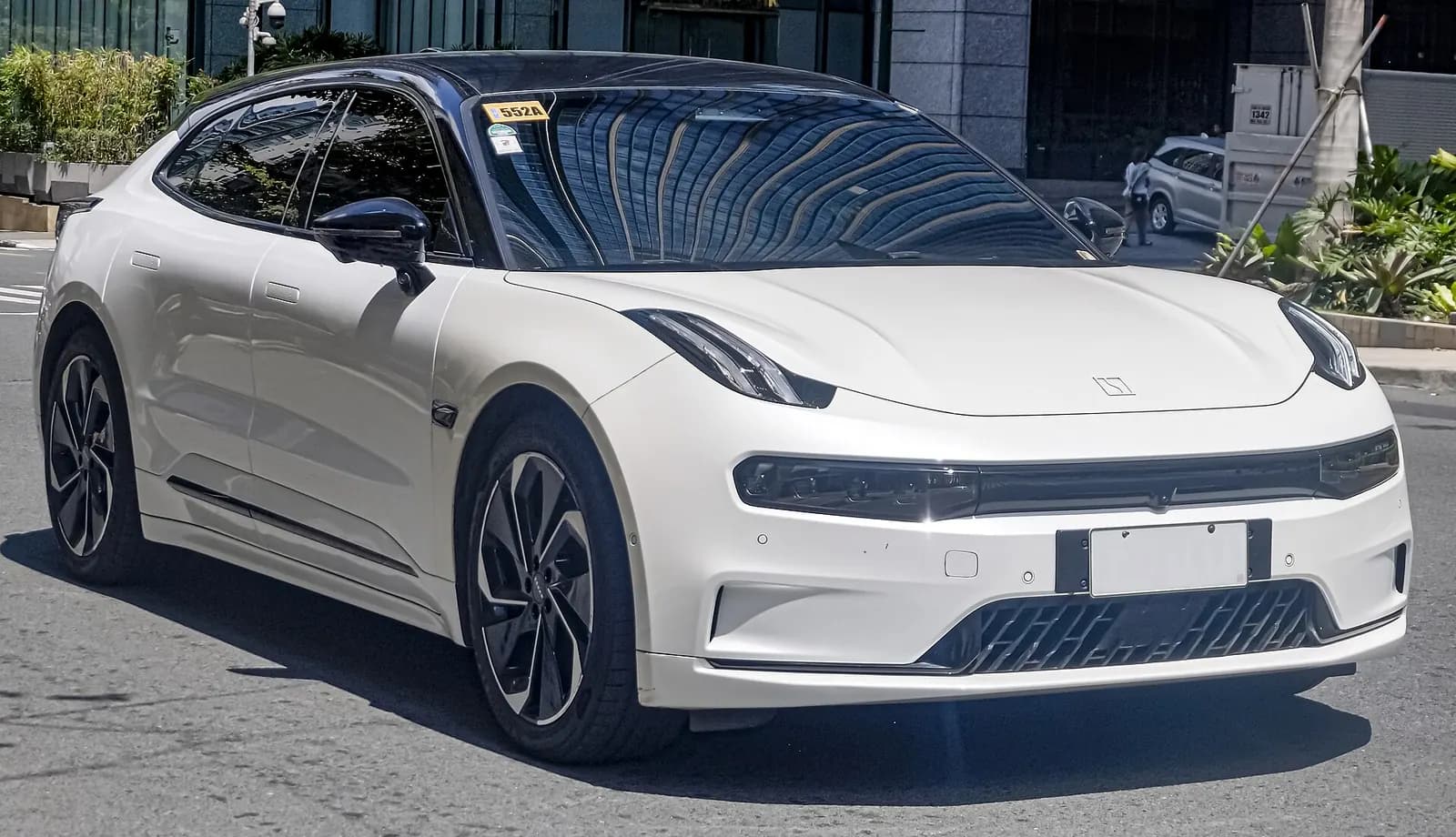 Front three-quarter view of a white Zeekr 001 with a blank number plate